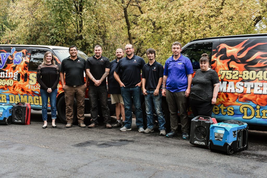 Stat Restoration crew standing in front of their vans Kalispell MT