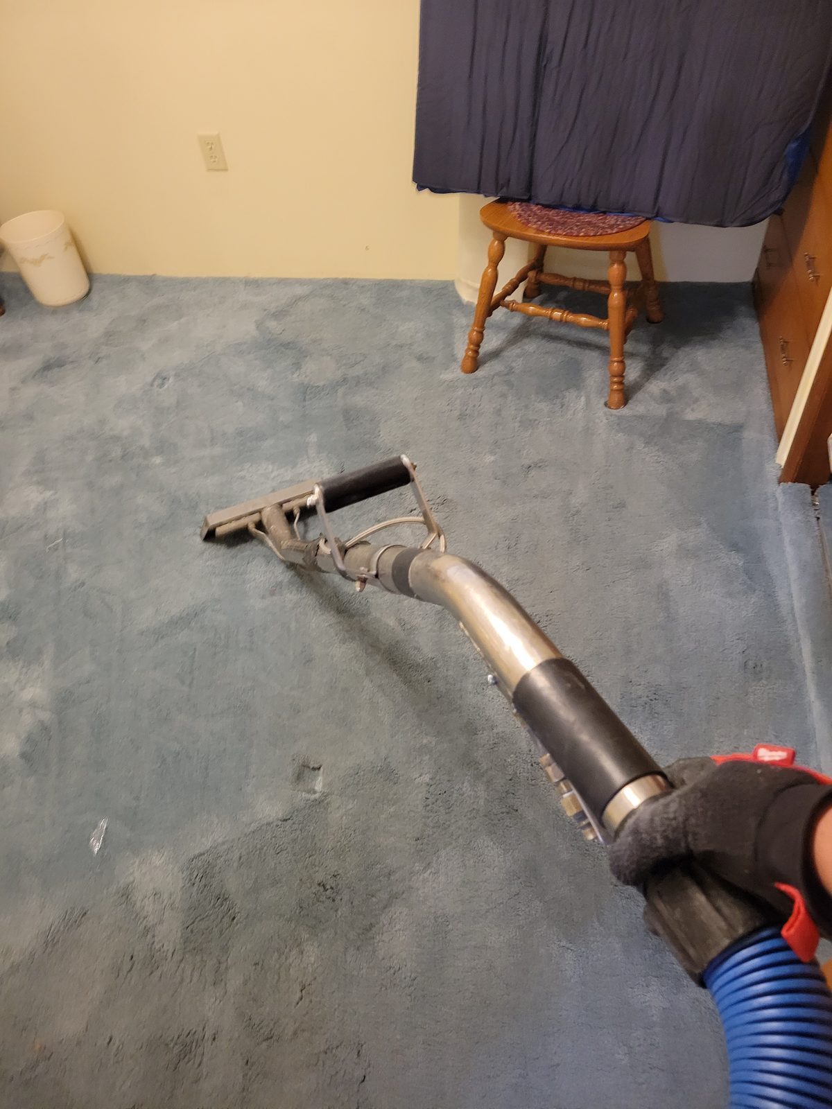 Stat technician extracting water from a wet carpet